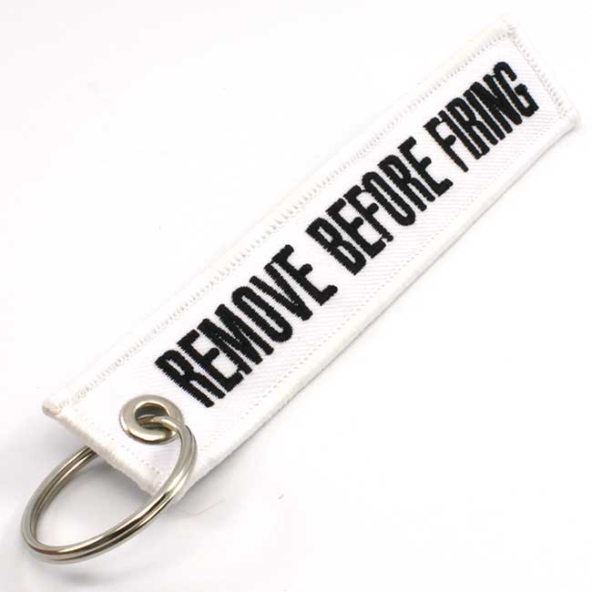 Remove Before Firing Keychain - White/Black